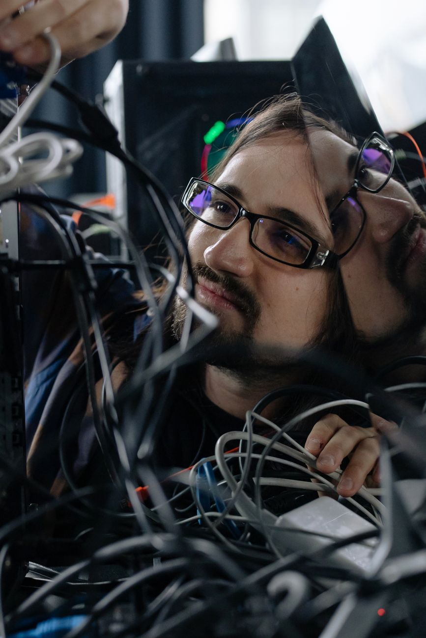 Technician working among cables and equipment